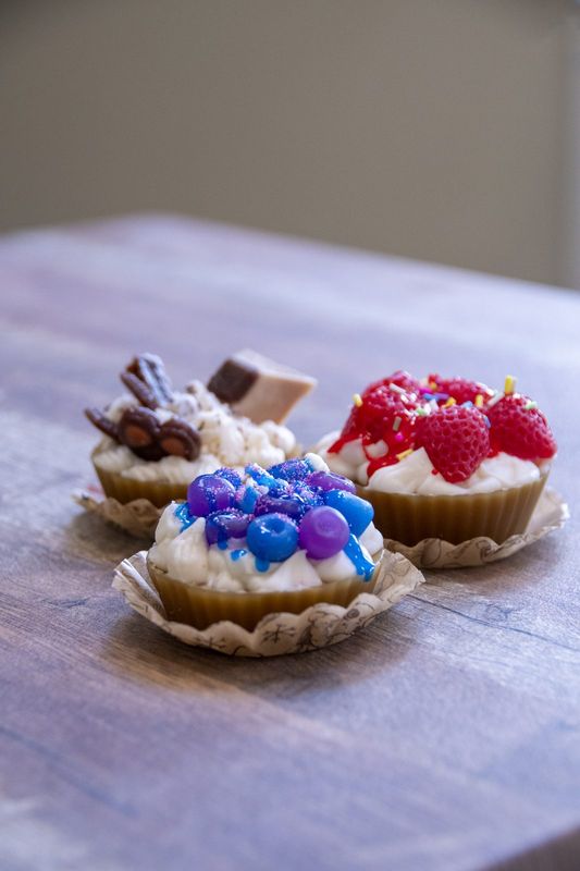 Fruit tartlet candles on a pale cloth