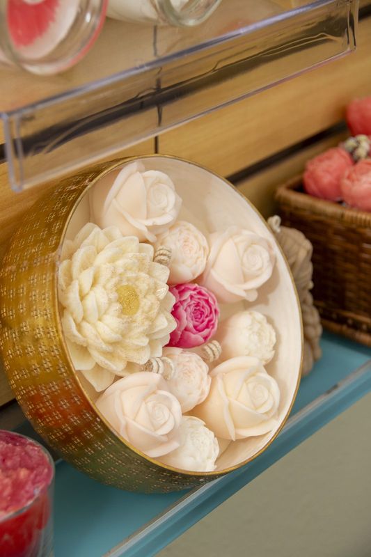 A gold tray of cream and pink wax roses